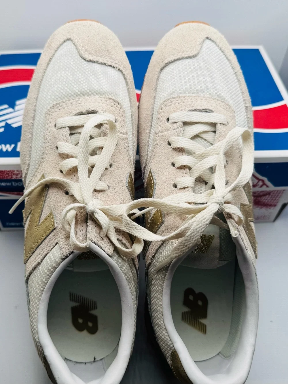 New Balance Women’s White Sneakers with Gold Accents